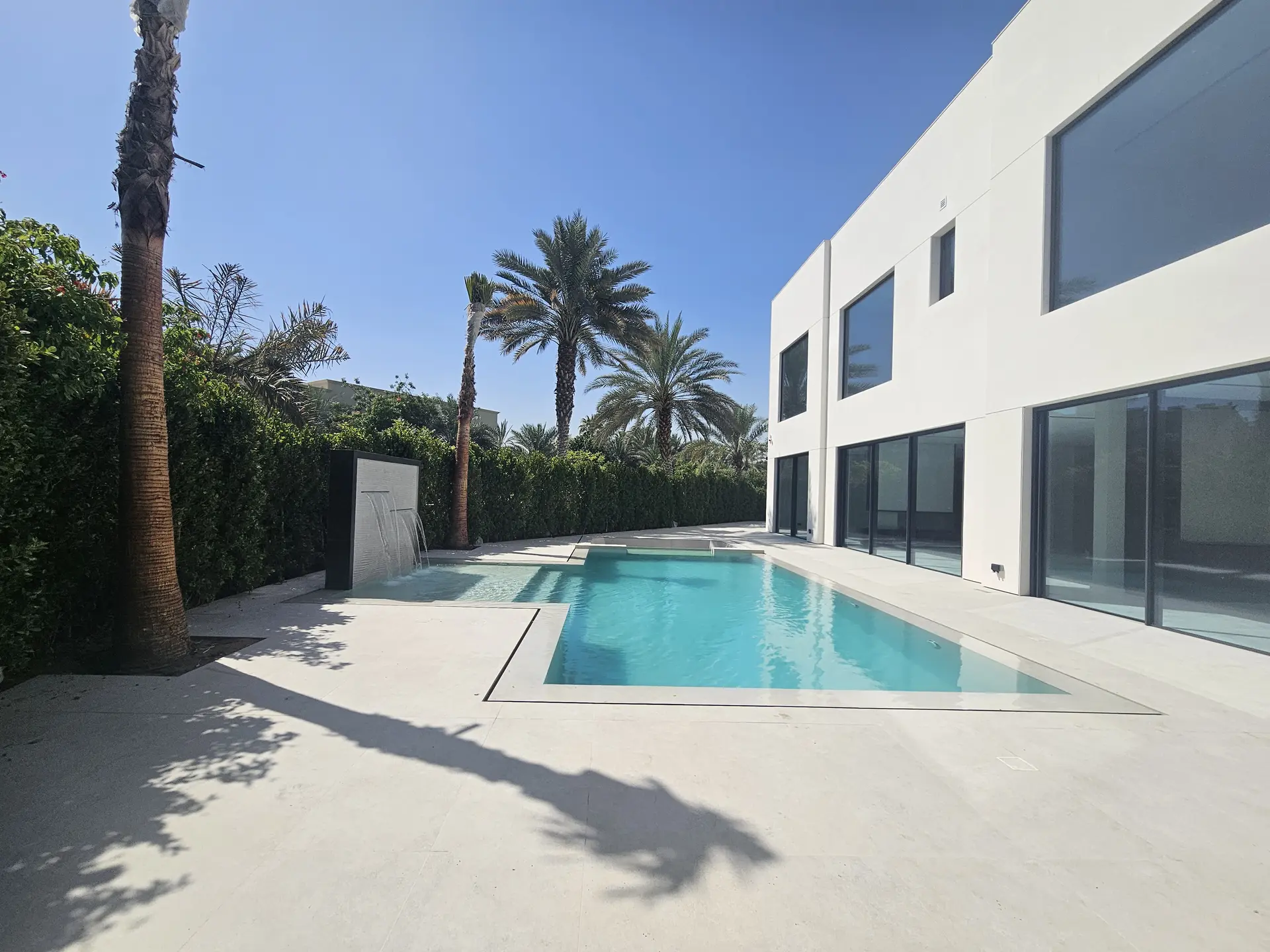 Emirates Hills villa pool and garden — KNX smart home integration by obliq
